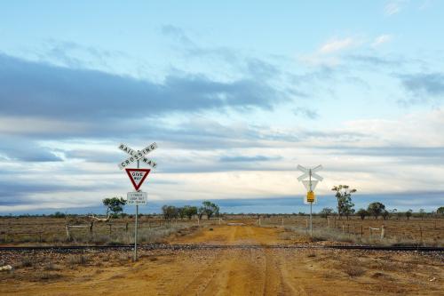 Dirt road railway crossing in remote location - Australian Stock Image