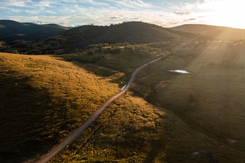 dirt road through granite belt landscape - Australian Stock Image