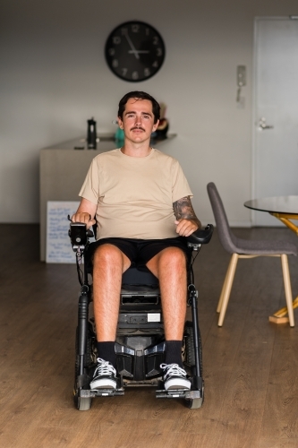 disabled man in motorised wheelchair - Australian Stock Image