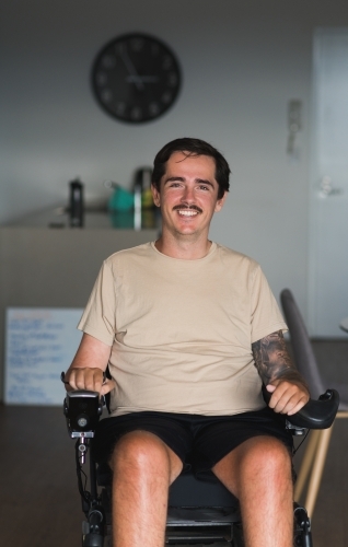 disabled man in wheelchair at home - Australian Stock Image