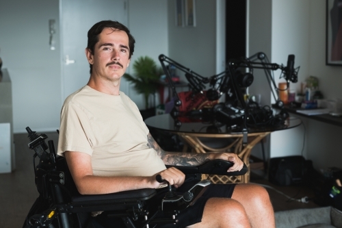disabled man in wheelchair at home - Australian Stock Image
