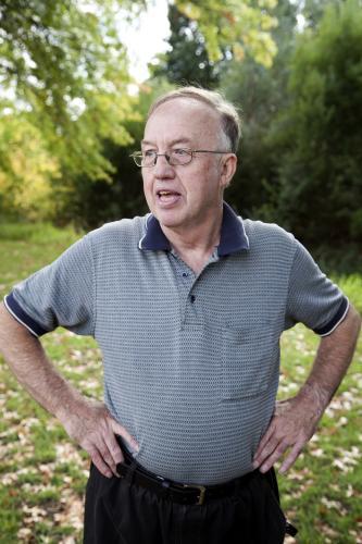 Disabled man standing outside with hands on hips - Australian Stock Image