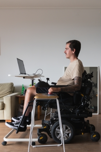 disabled man using computer, with special adaptive devices