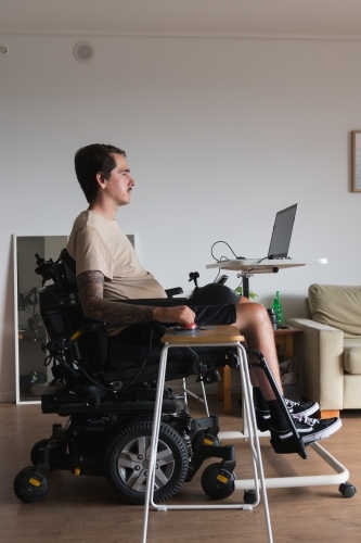 disabled man using computer, with special adaptive devices - Australian Stock Image