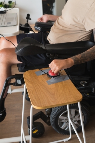 disabled man using computer, with special adaptive devices - Australian Stock Image