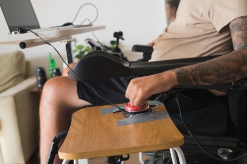 disabled man using computer, with special adaptive devices - Australian Stock Image