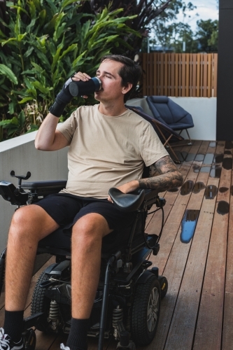 disabled man with custom made drinking cup