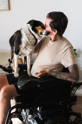 disabled man with his dog at home - Australian Stock Image
