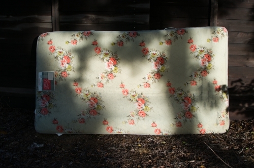 Discarded floral mattress