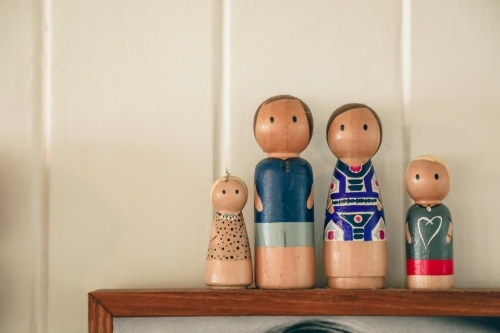 Display of wooden family figurines with white background. Nuclear family - Australian Stock Image