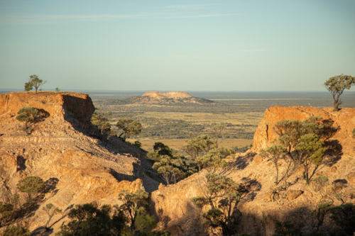 Distant mesa hill framed by two close mesa hills - Australian Stock Image