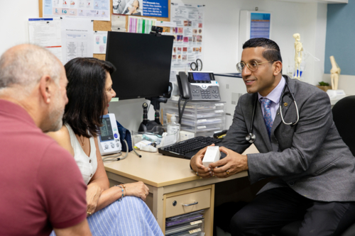 Doctor handing prescription medicine to female patient - Australian Stock Image