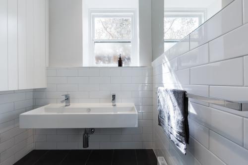 Double basin vanity in modern white renovated bathroom in heritage building horizontal