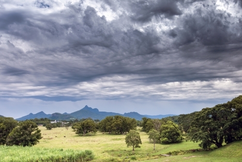 Dramatic storm clouds over mountain range - Australian Stock Image