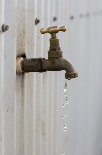Dripping tap on currugated tin shed - Australian Stock Image