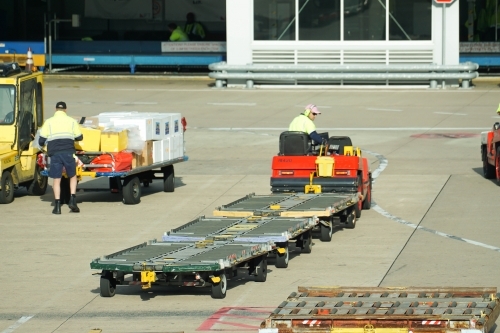 Driver with airport baggage cart - Australian Stock Image