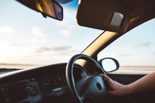 Driving a car into the sunset - Australian Stock Image