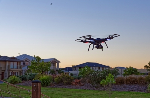 Drone flying at sunset in empty park with copy space - Australian Stock Image