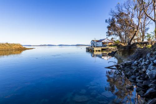 Dunalley Canal with fish markets in the background - Australian Stock Image