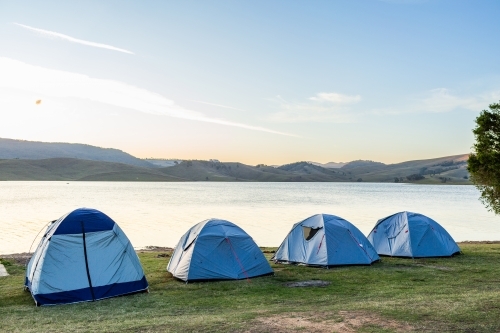 Dusk light over tents at lakeside campground  - Australian Stock Image
