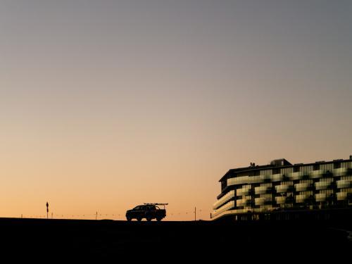 Dusk silhouette car and a hotel on Mt Panorama Racing Circuit - Australian Stock Image
