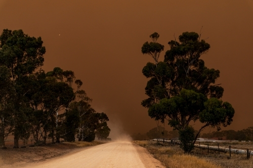 dust storm blowing in over dirt road - Australian Stock Image