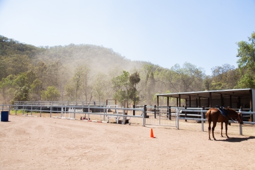 Dusty blowing trough riding school - Australian Stock Image
