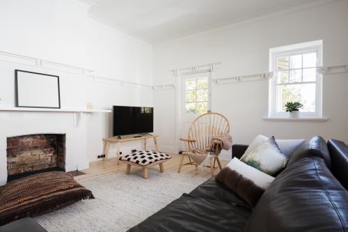 Eclectic styled contemporary living room in older spacious Melbourne apartment - Australian Stock Image