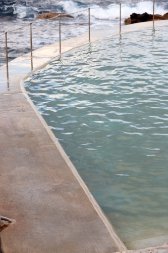 Edge of concrete floor at sea pool - Australian Stock Image