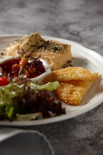 Eggs and hashbrowns with salad - Australian Stock Image