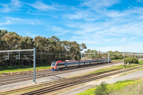 Electric passenger train departing from the Mile End Railway Station and heading to Adelaide city - Australian Stock Image