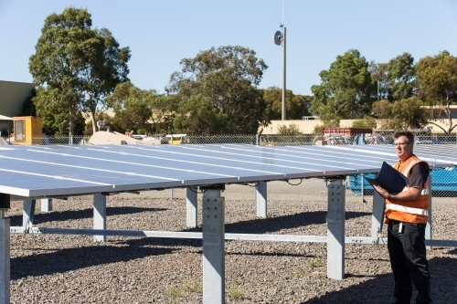 Employee taking notes at a Solar Panel plant - Australian Stock Image