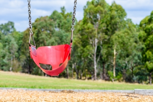 Empty chain swing in the playground in park - Australian Stock Image