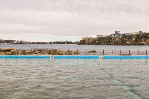 Empty ocean pool with urban and suburban background - Australian Stock Image