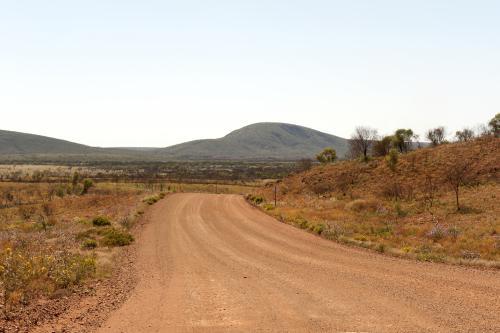 Empty Pilbara dirt road and landscape in early morning