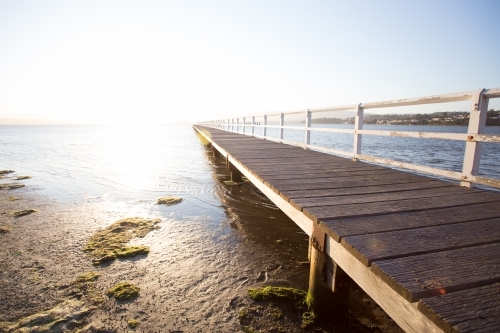 Endless jetty on a lake at sunset - Australian Stock Image