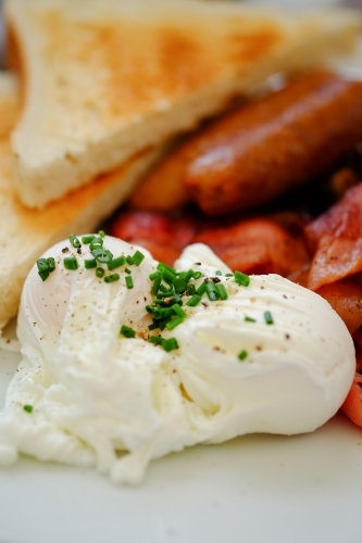English breakfast of eggs, bacon, sausages and toast - Australian Stock Image