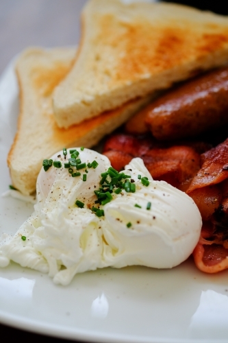 English breakfast of eggs, bacon, sausages and toast - Australian Stock Image