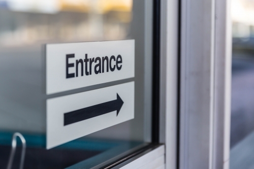 Entrance sign with black arrow - Australian Stock Image