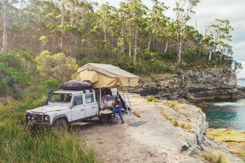 epic campsite on a ledge by the ocean, Bruny Island, Tasmania - Australian Stock Image