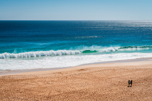Ethel Wreck Beach with two unidentified women walking along on a bright day, Yorke Peninsula - Australian Stock Image