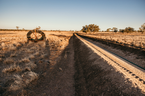 Excavated land to lay pipelines on a dry grassland - Australian Stock Image