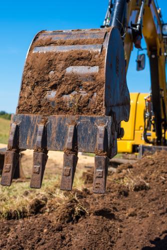 Excavator bucket reaching out to dig - Australian Stock Image