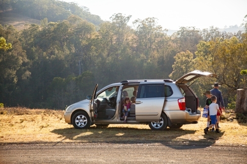 Family getting out of car stopped on the roadside for a break - Australian Stock Image