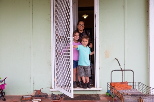 Family going out of front door of home - Australian Stock Image