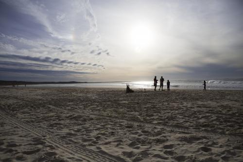 Family hanging out on the beach - Australian Stock Image