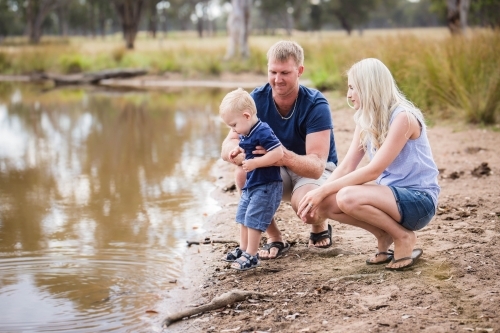 Family on farm near water in dam - Australian Stock Image