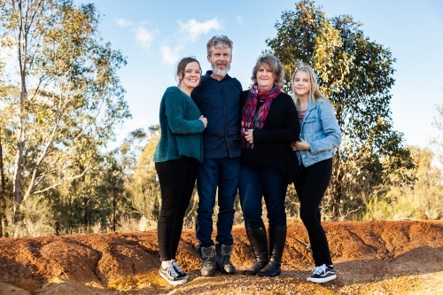 Family with teenage daughters together in australian landscape - Australian Stock Image