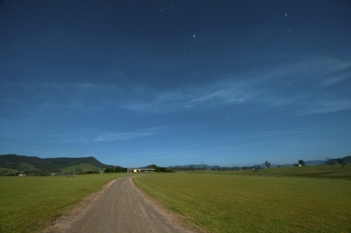 Farm land at night with some stars in the sky