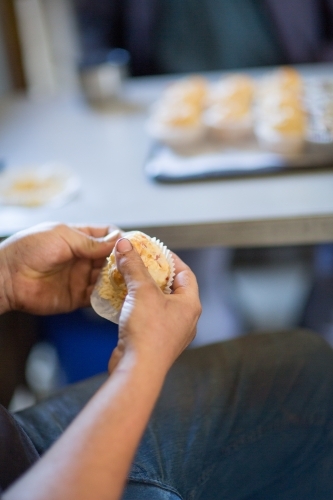 Farm worker having a muffin for smoko - Australian Stock Image